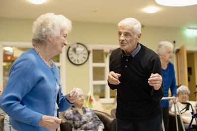 Group of older adults doing seated exercises in a community center