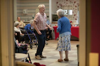 Elderly couple dancing in a community hall