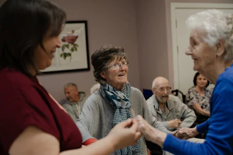 Elderly people enjoying a social gathering indoors.