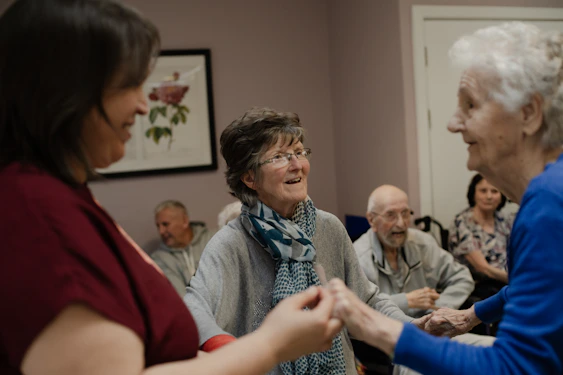 Elderly people enjoying a social gathering indoors.