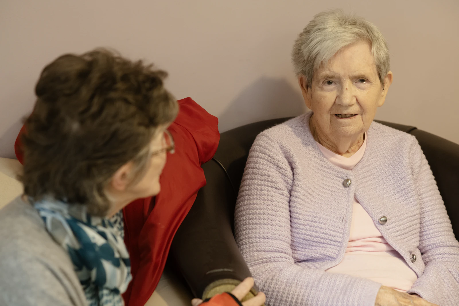 Two elderly women sitting together in conversation