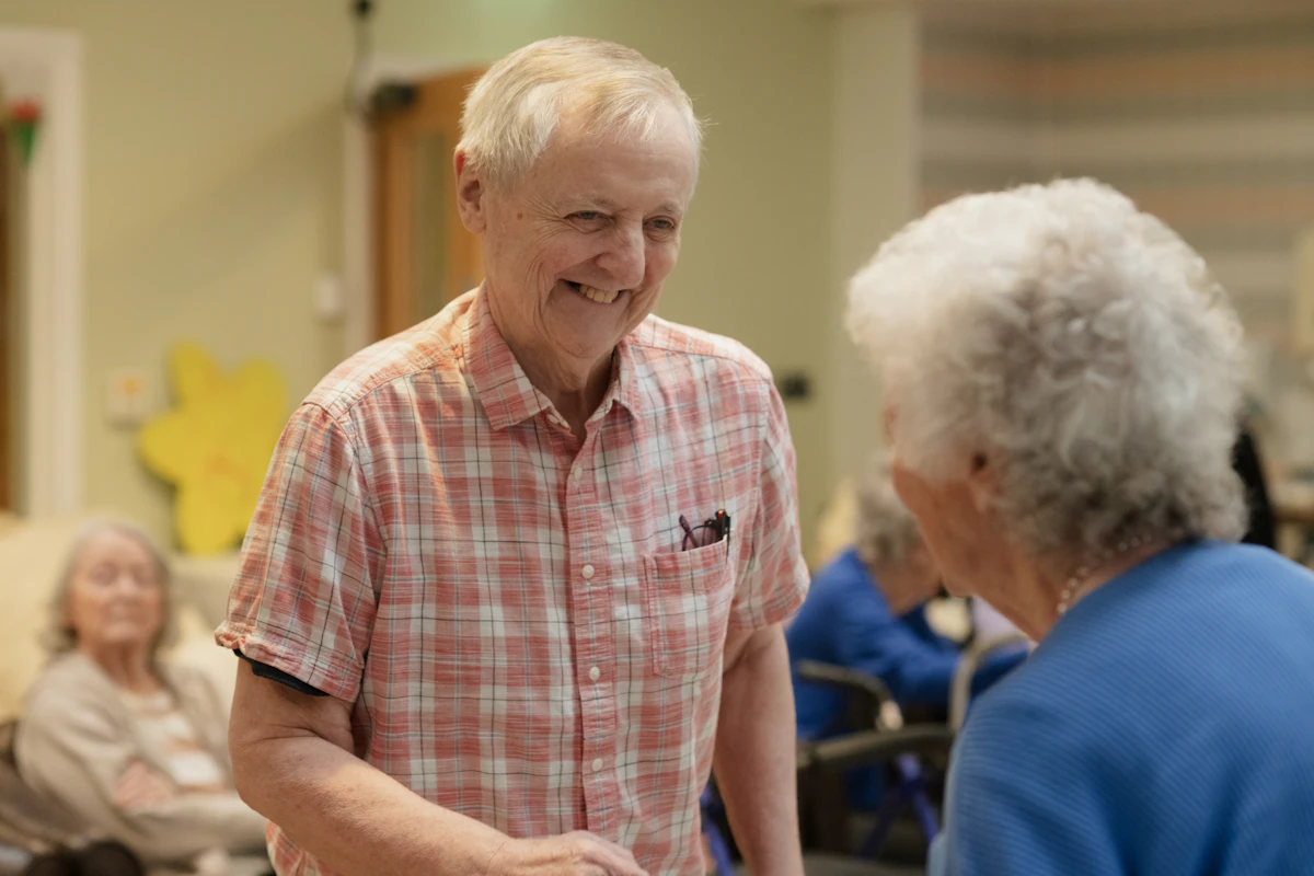 Support Worker holding hands with elder client