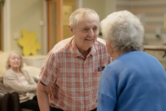Elderly couple talking in a room