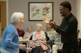 Man clapping hands with an elderly woman.