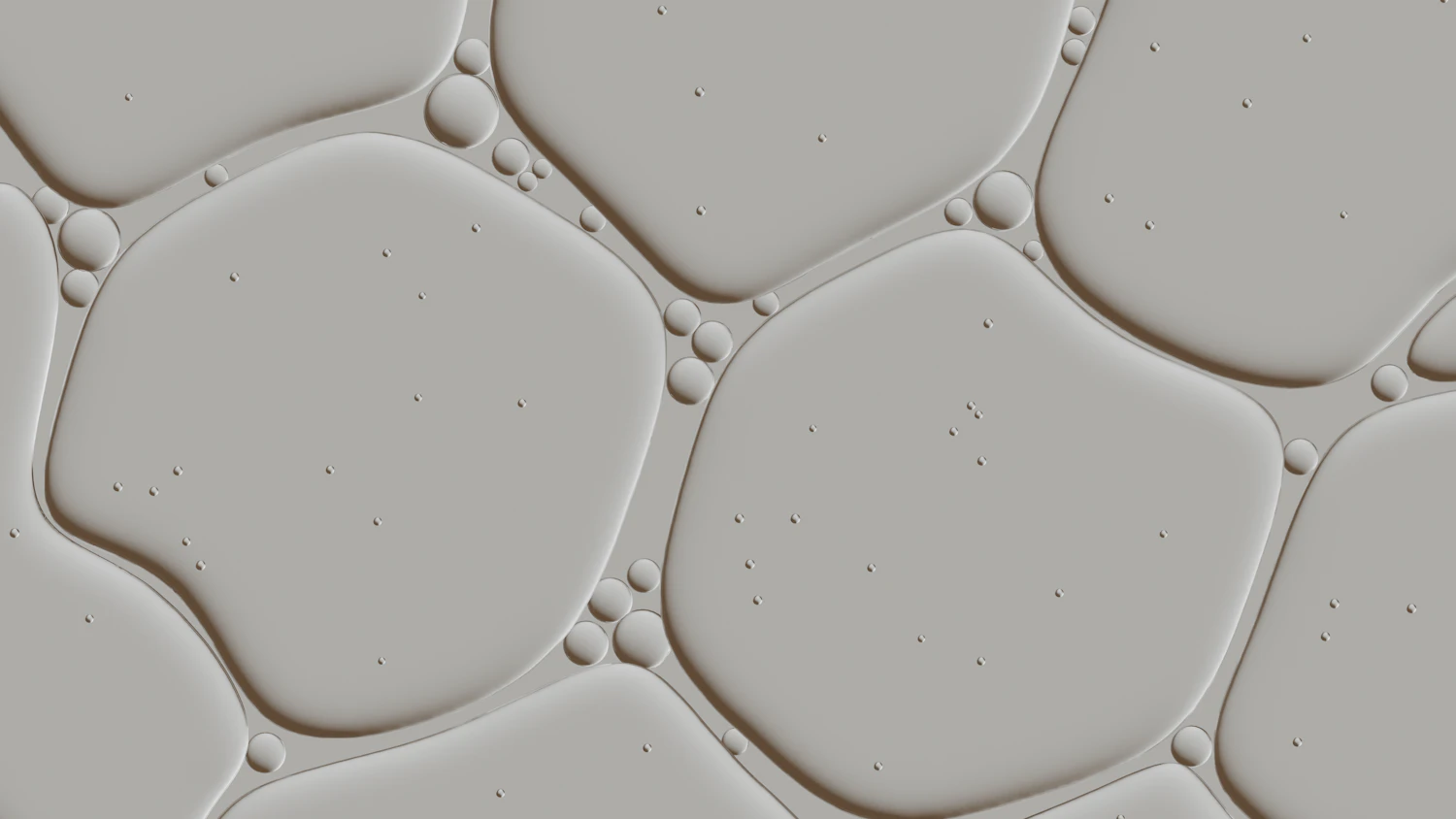 A film of pale gel breaking into cells across a flat surface