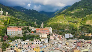 Colorful village nestled in a lush green mountain valley.