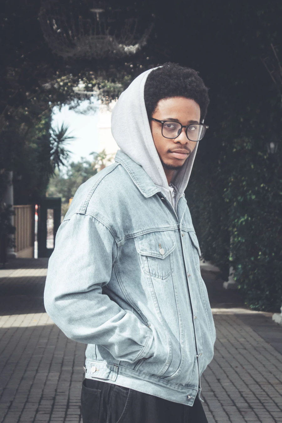Man in a denim jacket and hoodie