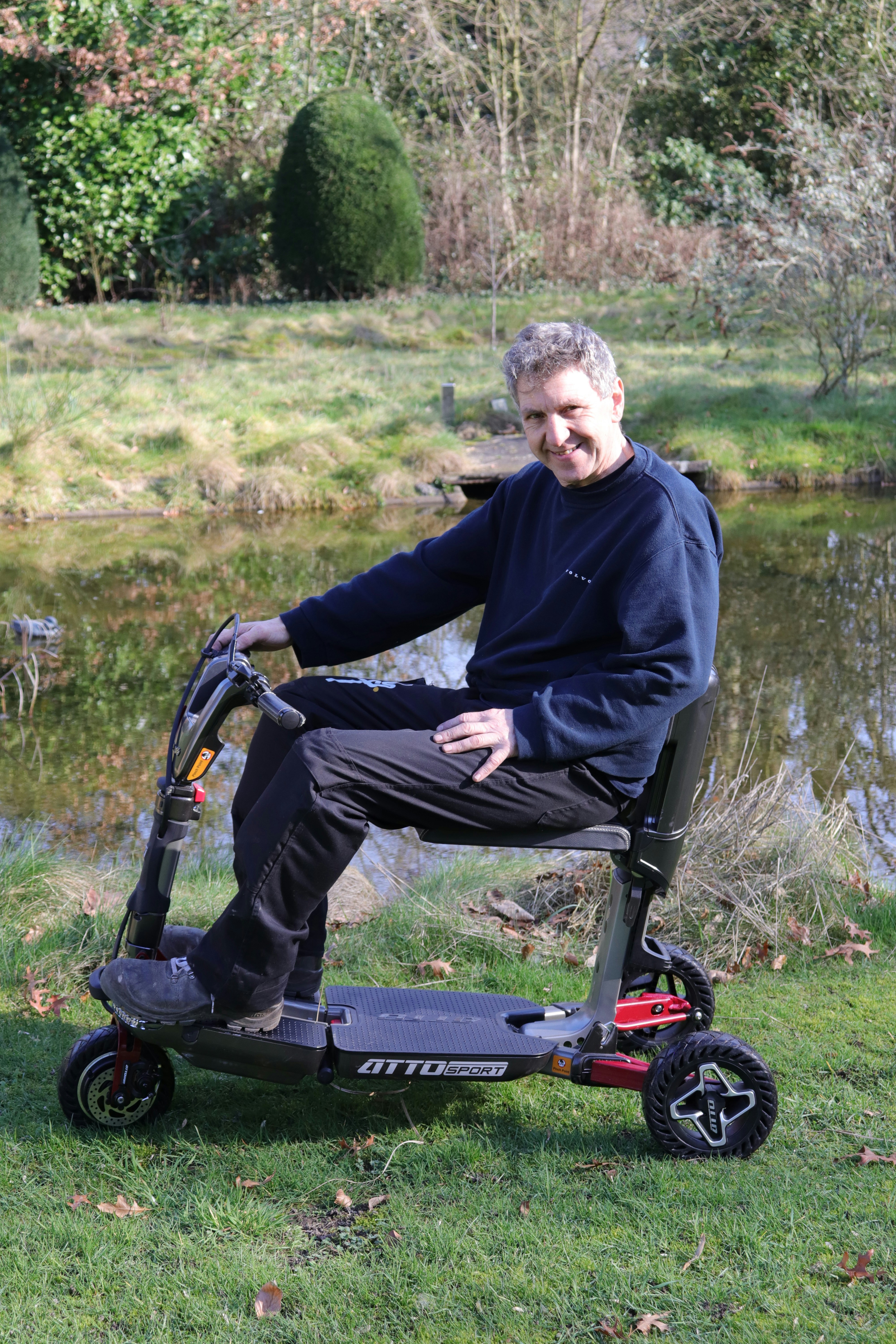 Man sitting on a mobility scooter outdoors