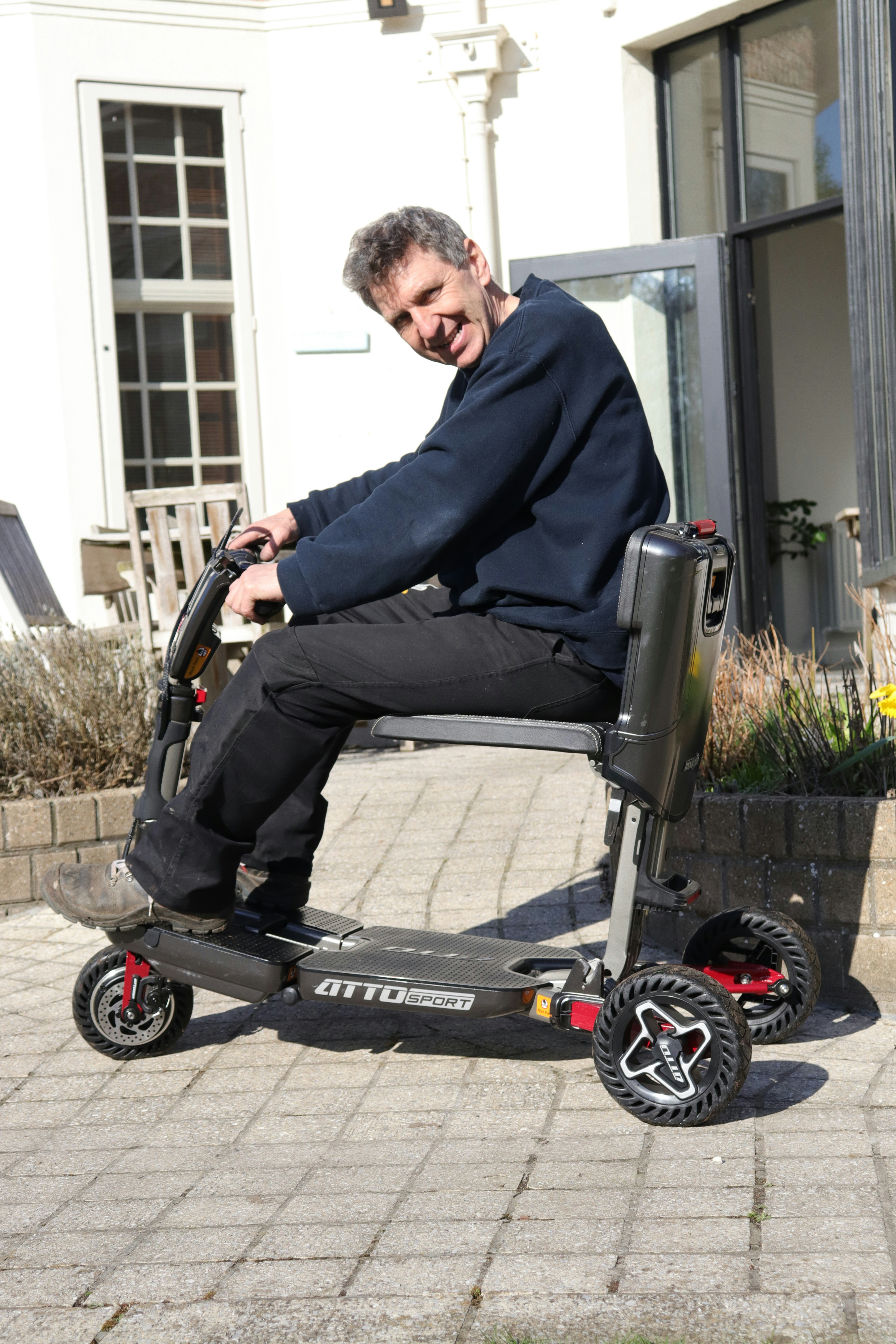 Man riding a mobility scooter outdoors