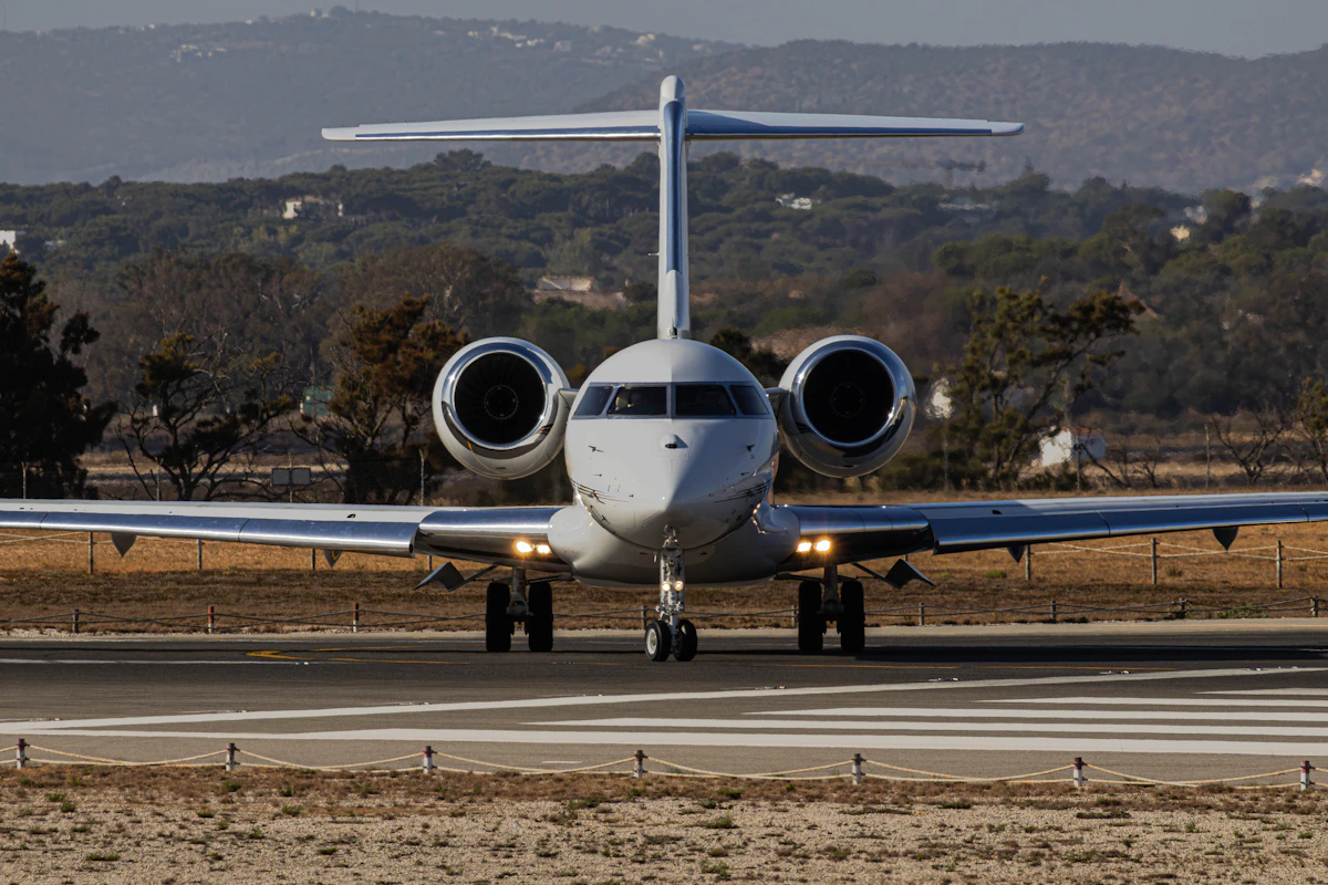 A large-cabin business jet taxiing head-on along a runway, the long-range aircraft that heavy jet charter cost pays for