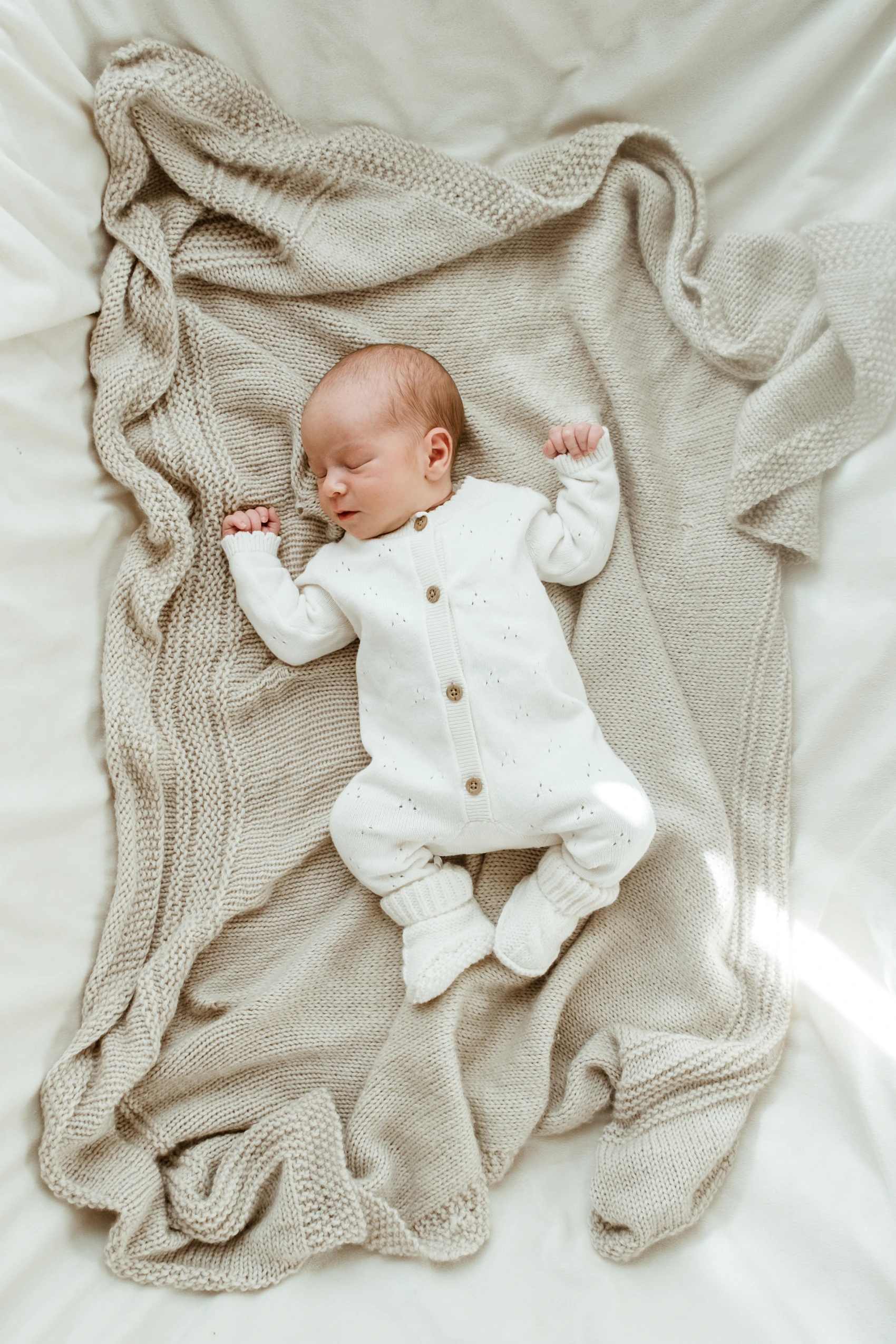 Newborn baby resting peacefully on a soft comfortable blanket