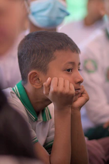 Young boy resting his chin on his hands