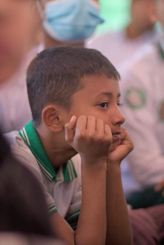Young boy resting his chin on his hands