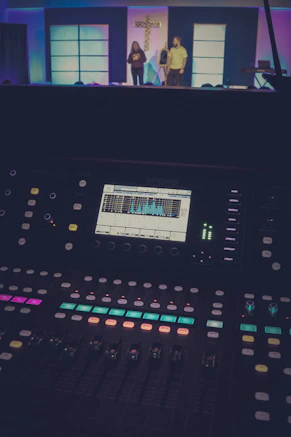 Sound mixing board in front of a stage