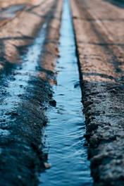Water flows through a narrow irrigation ditch