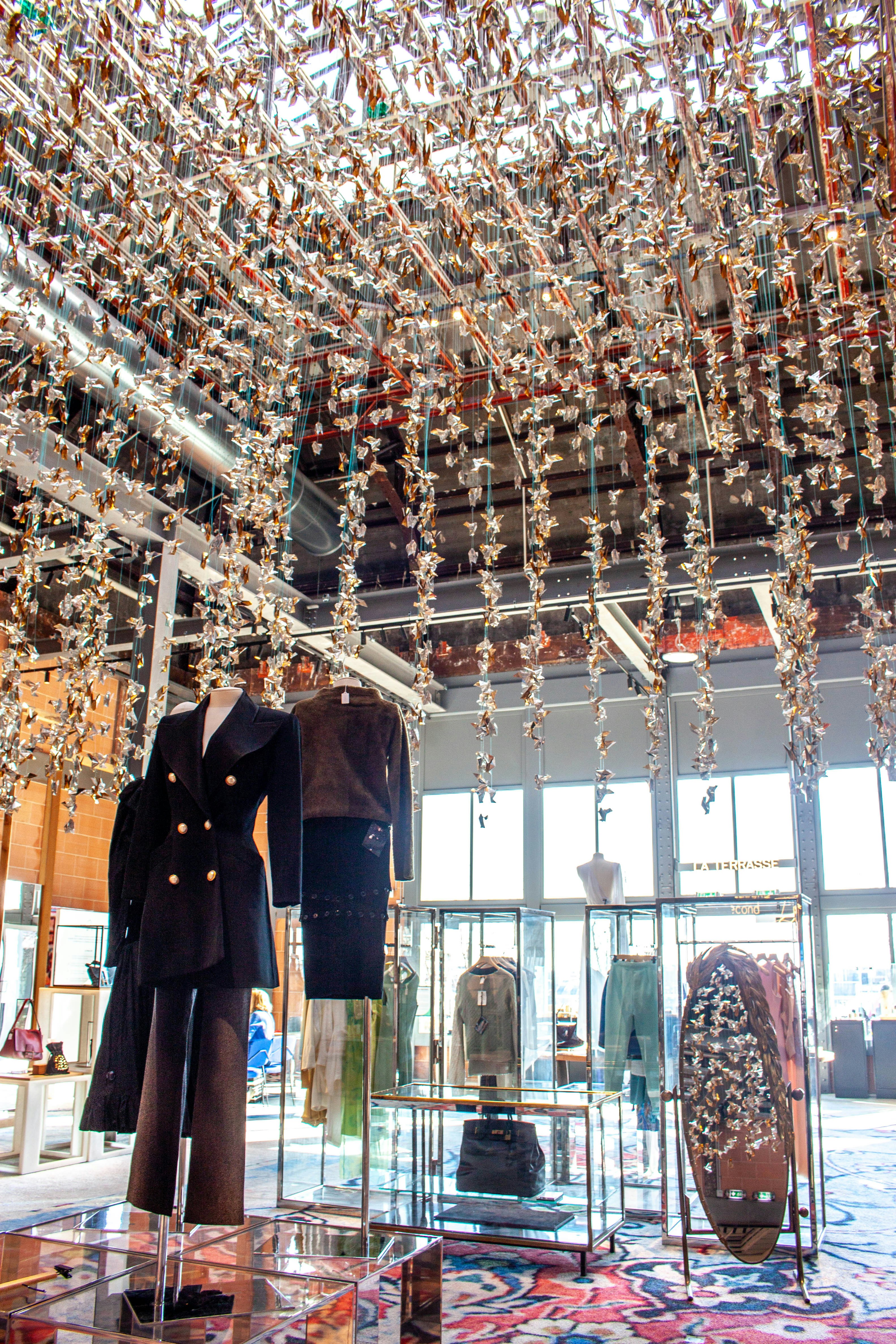 Mannequins display clothing in a well-lit retail store.