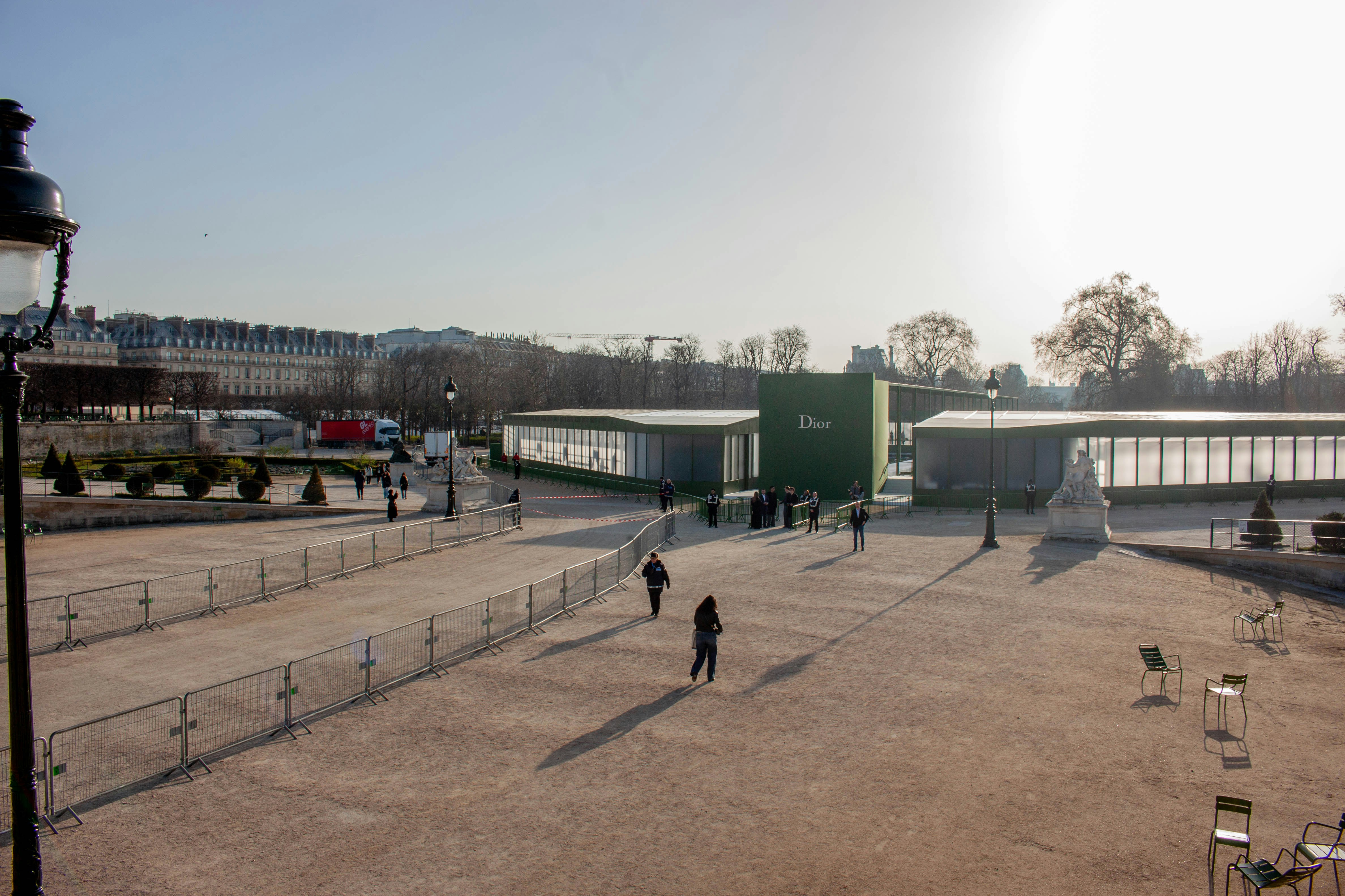 People walking through a park with modern buildings