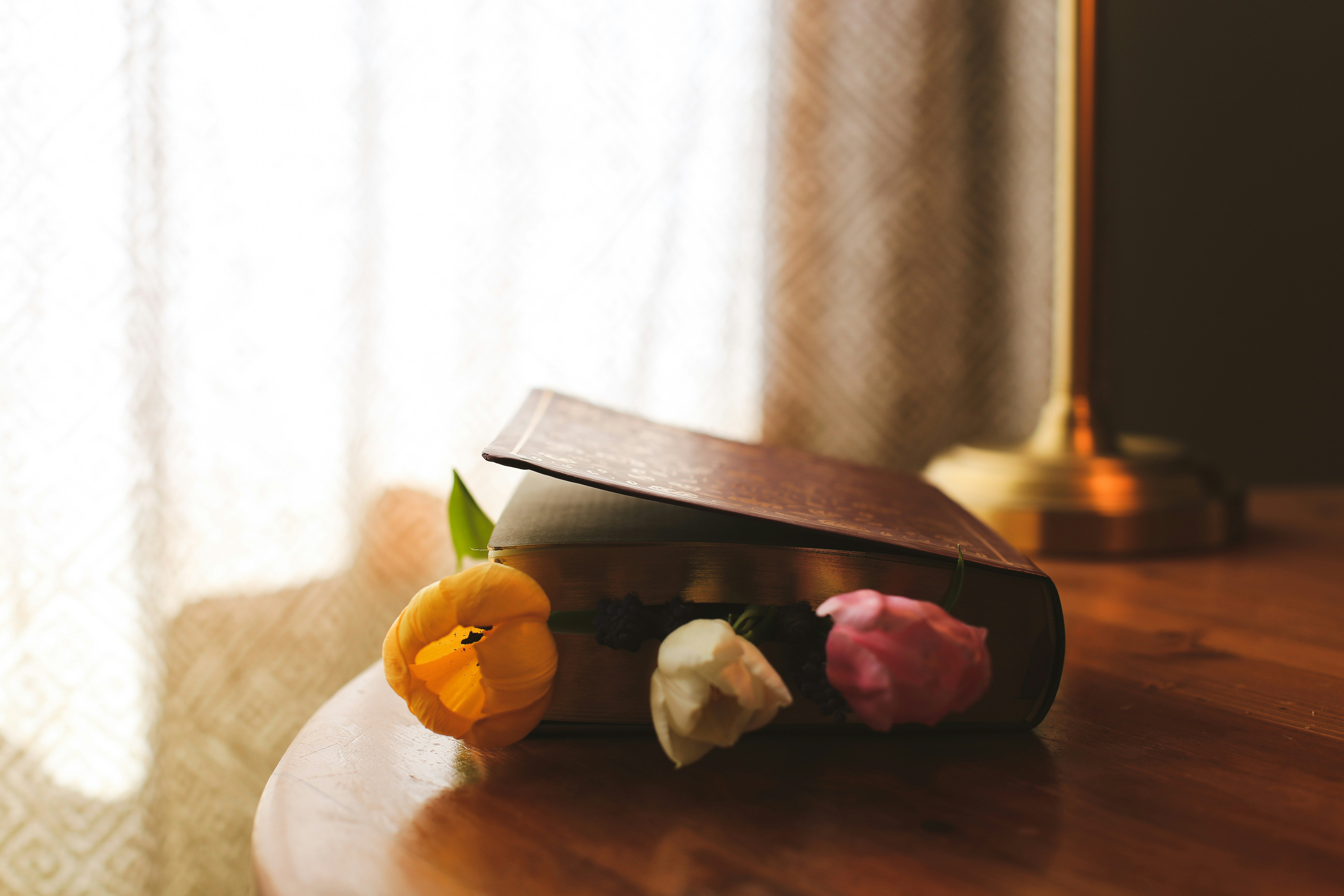 A book with flowers on a wooden table