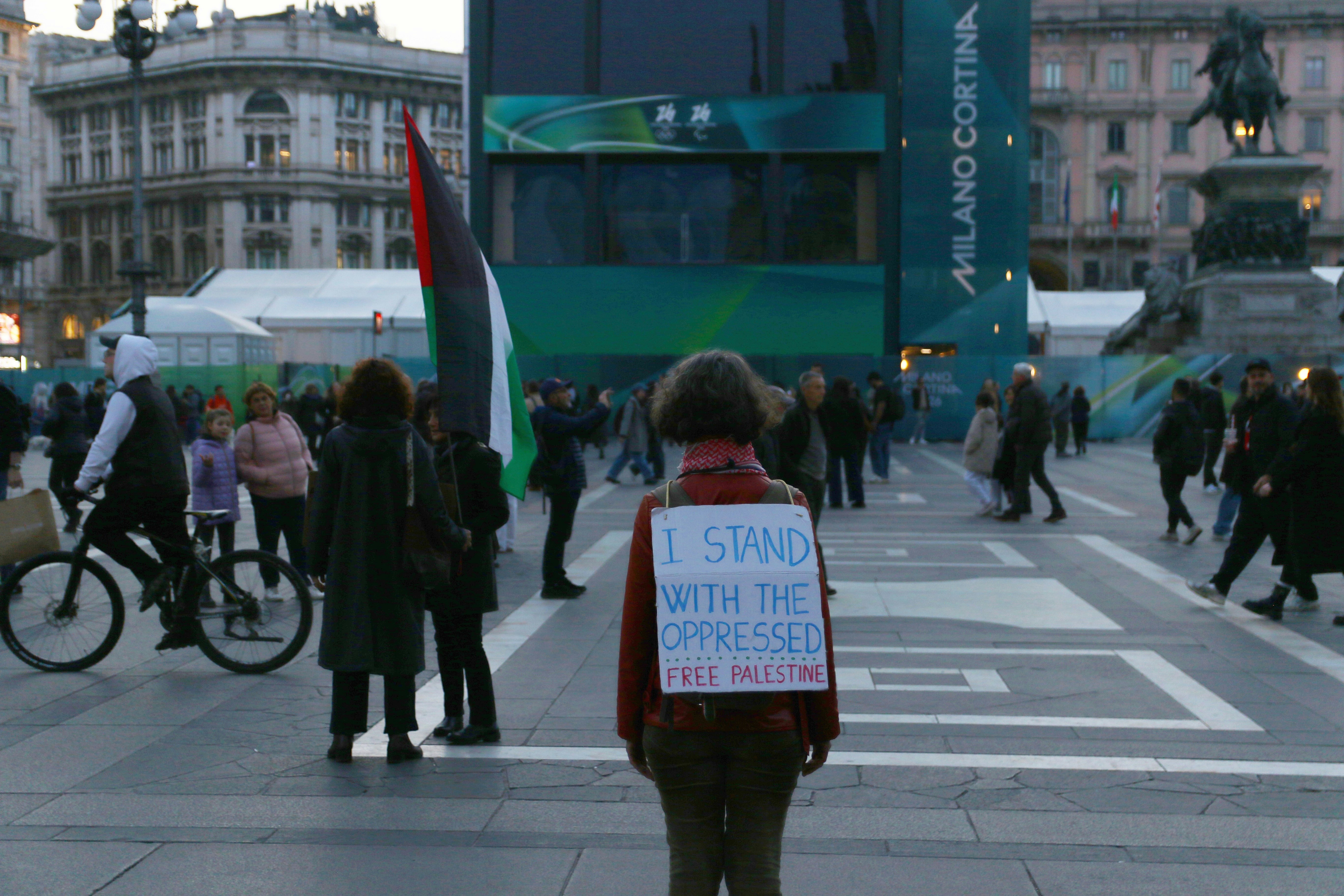 Person holds sign supporting palestine during a protest.