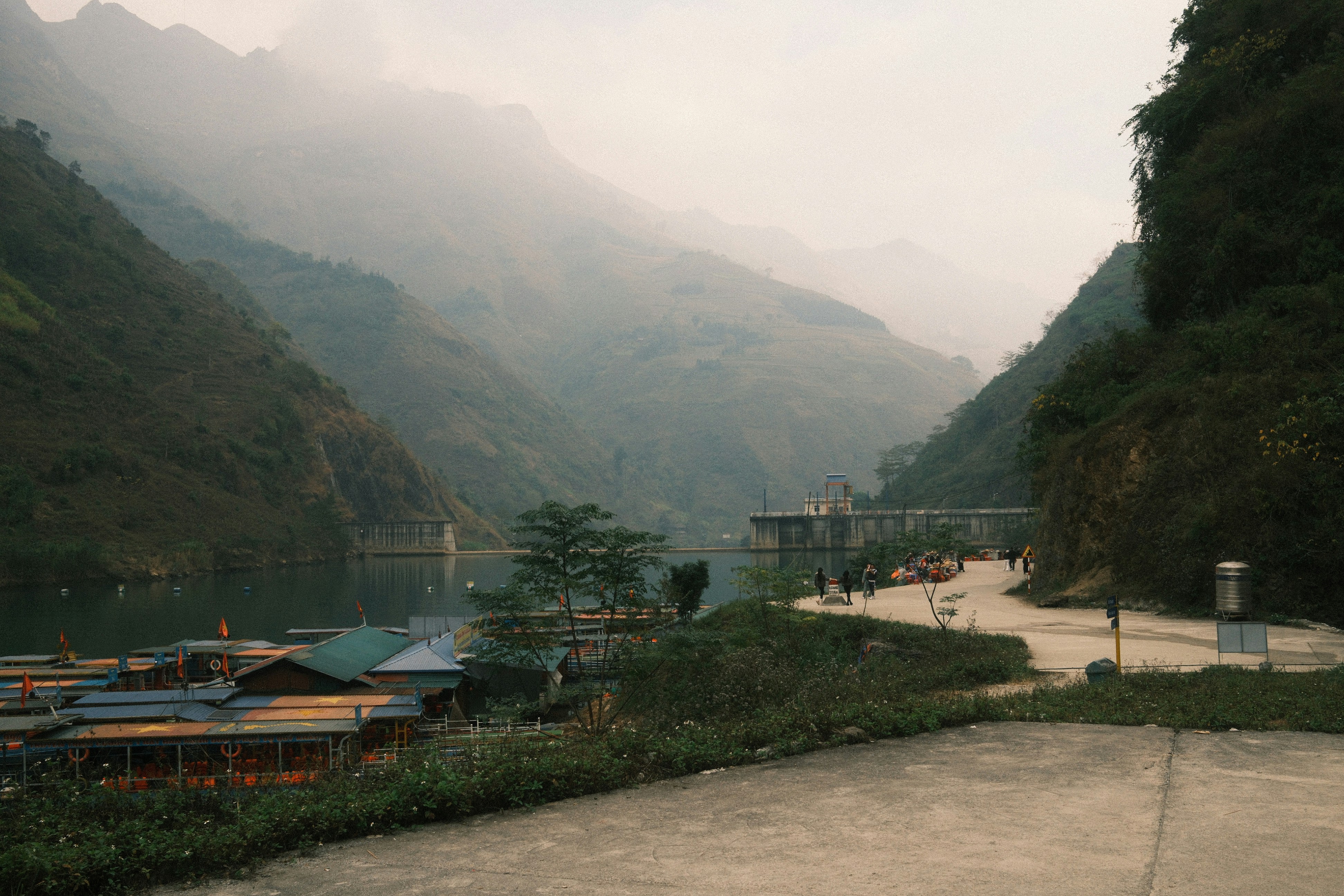 Misty mountains overlook a village by the water photo – Free Travel ...