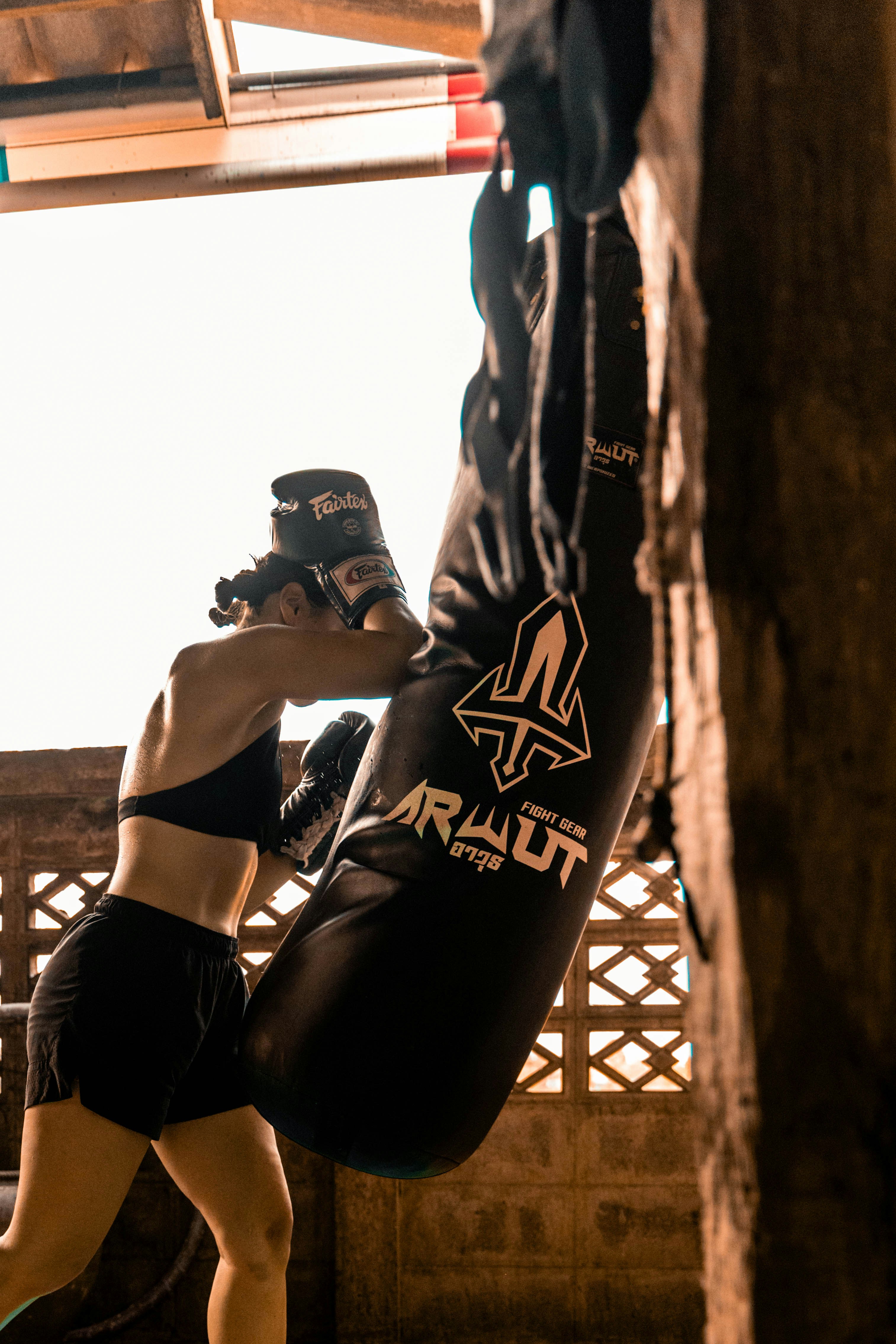 Woman punching a heavy bag during training