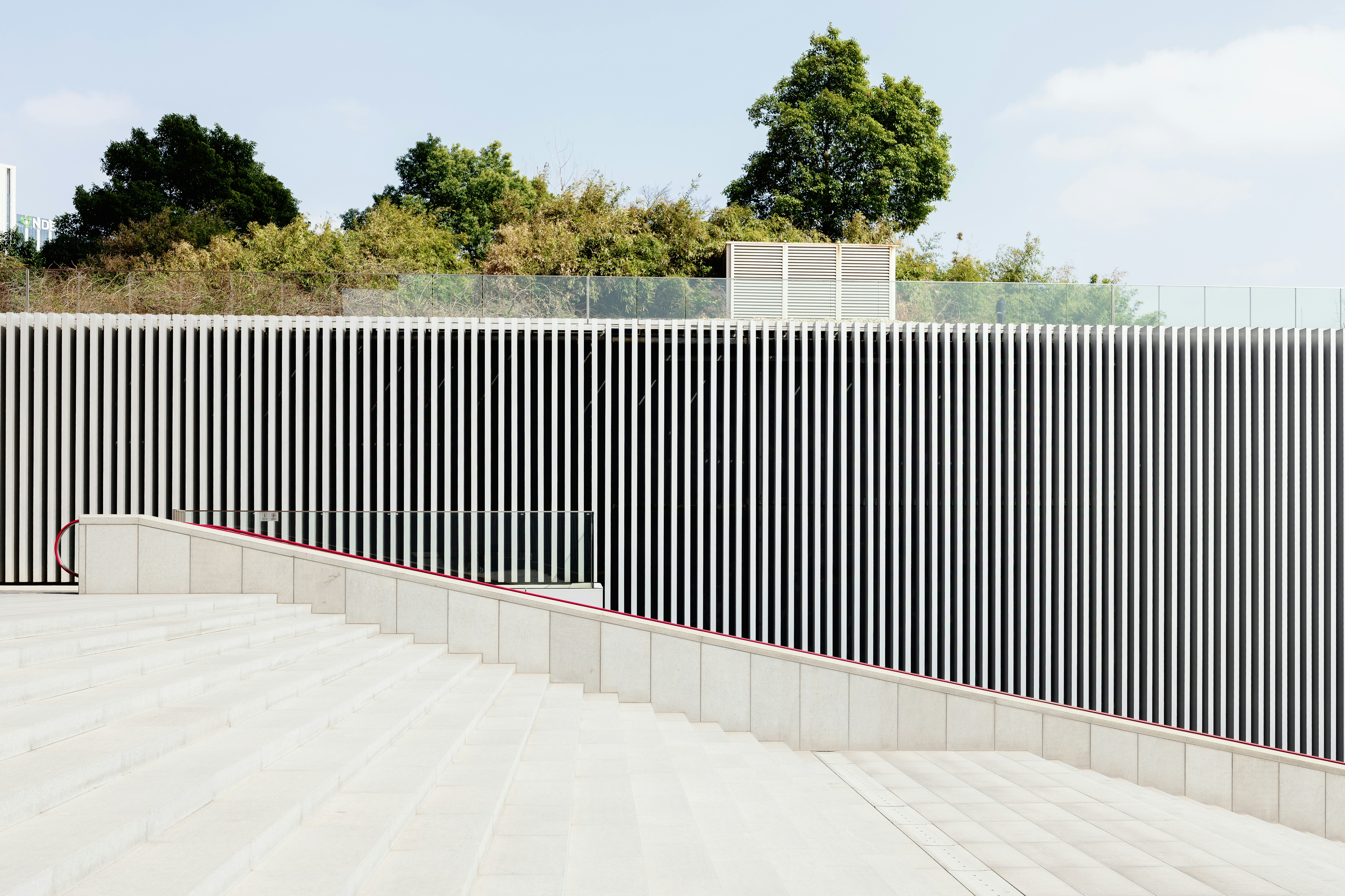 Modern building facade with vertical lines and trees