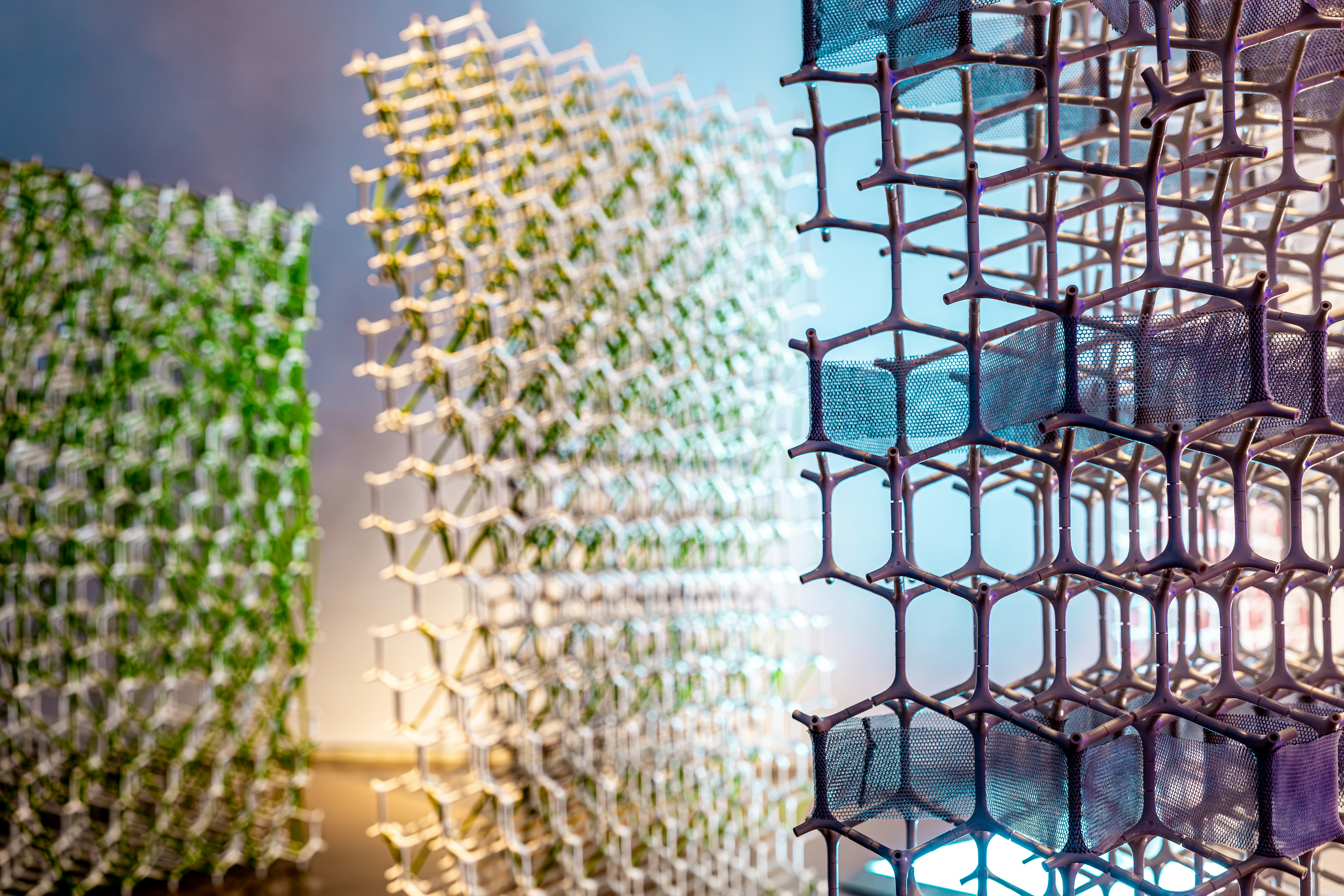 Three abstract geometric structures with hexagonal patterns