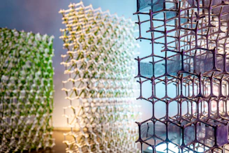 Three abstract geometric structures with hexagonal patterns