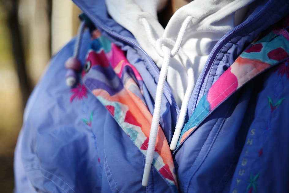 Person wearing a colorful patterned jacket outdoors