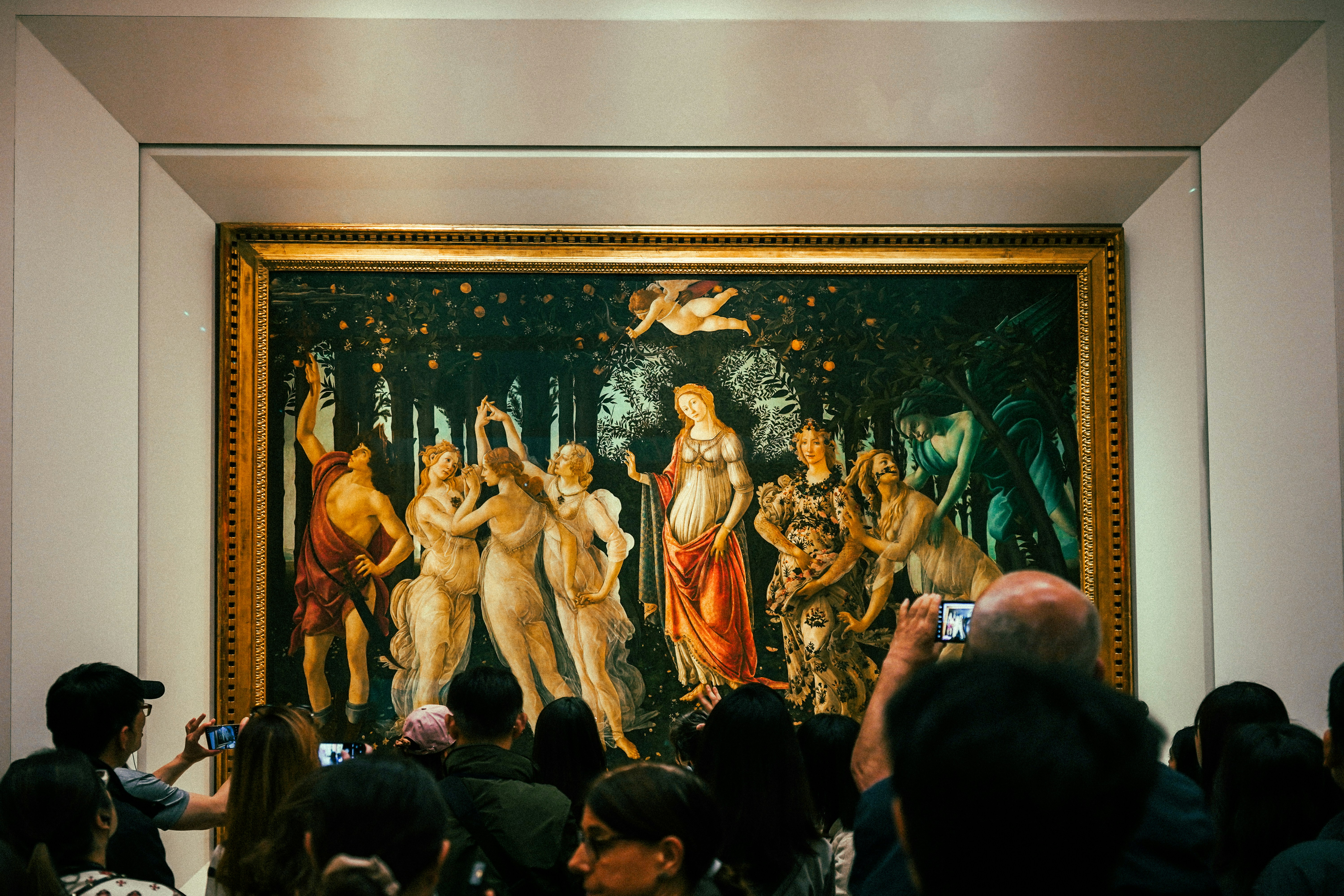 People admire a renaissance painting in a museum.