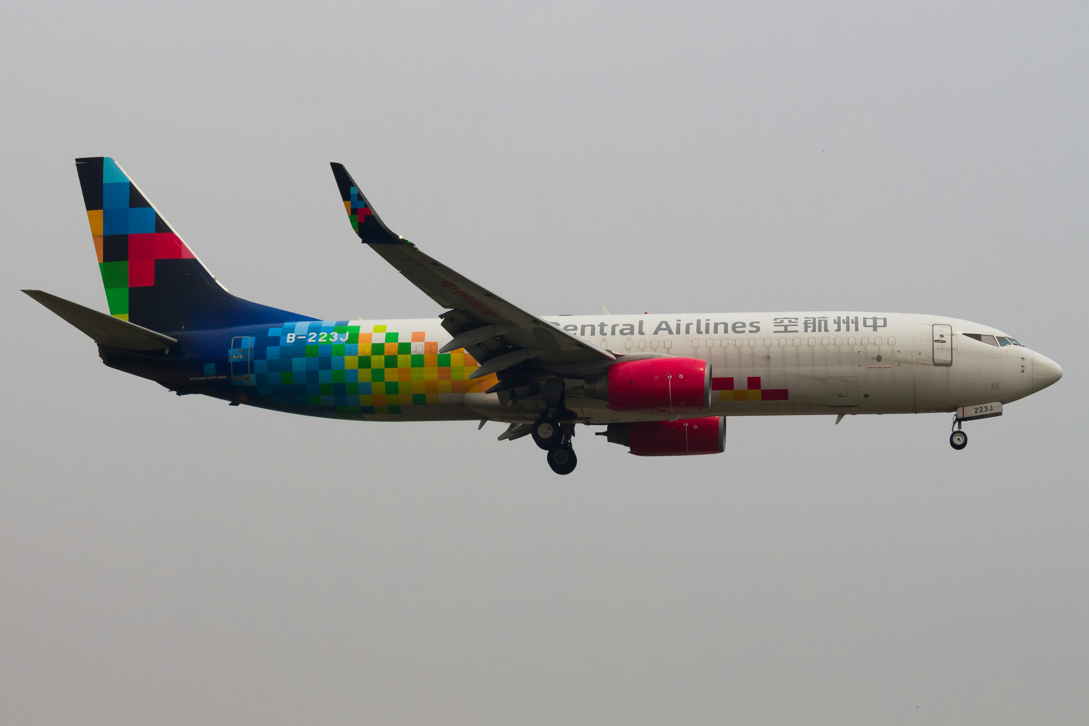A commercial airplane with colorful livery lands