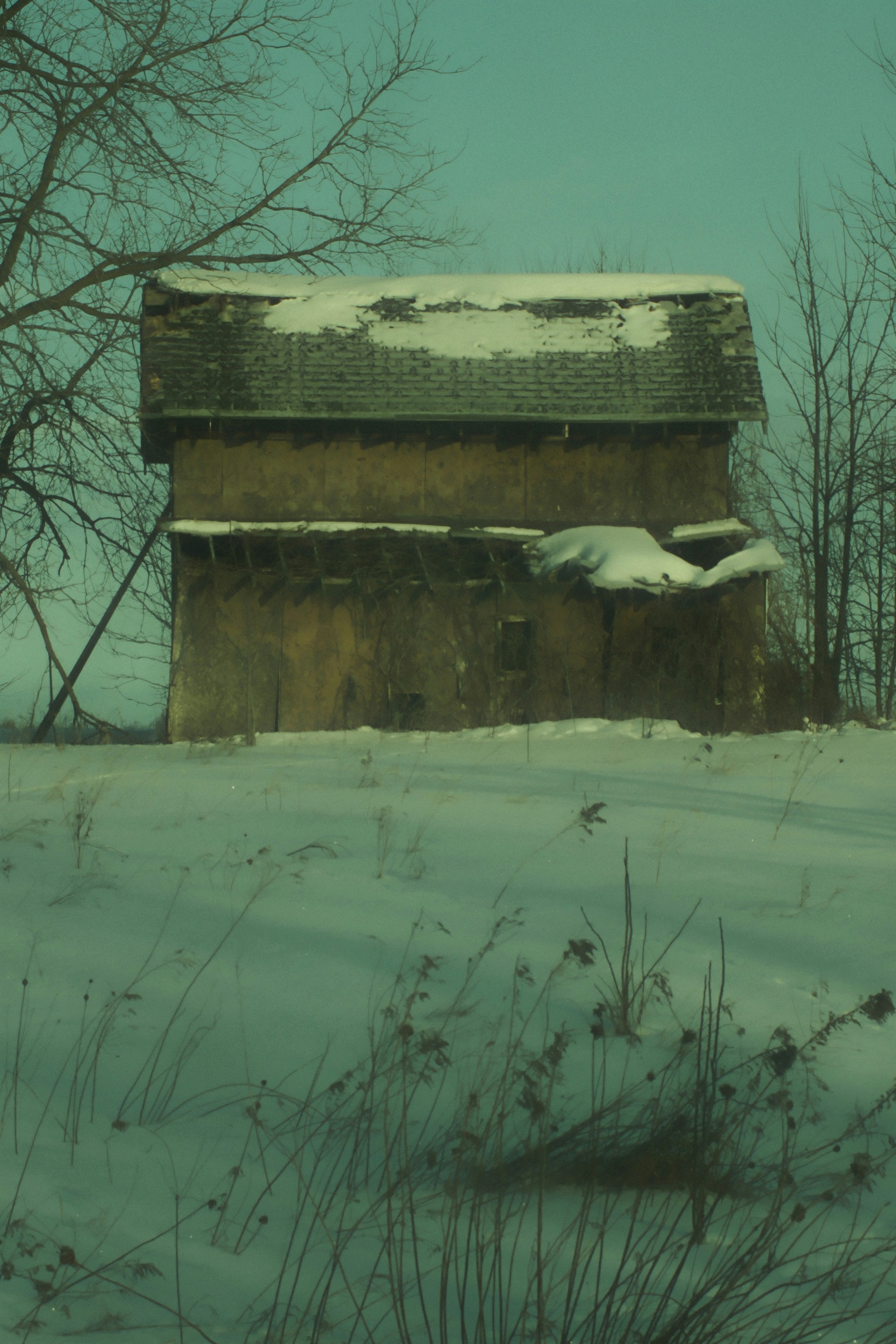 Old barn covered in snow during winter