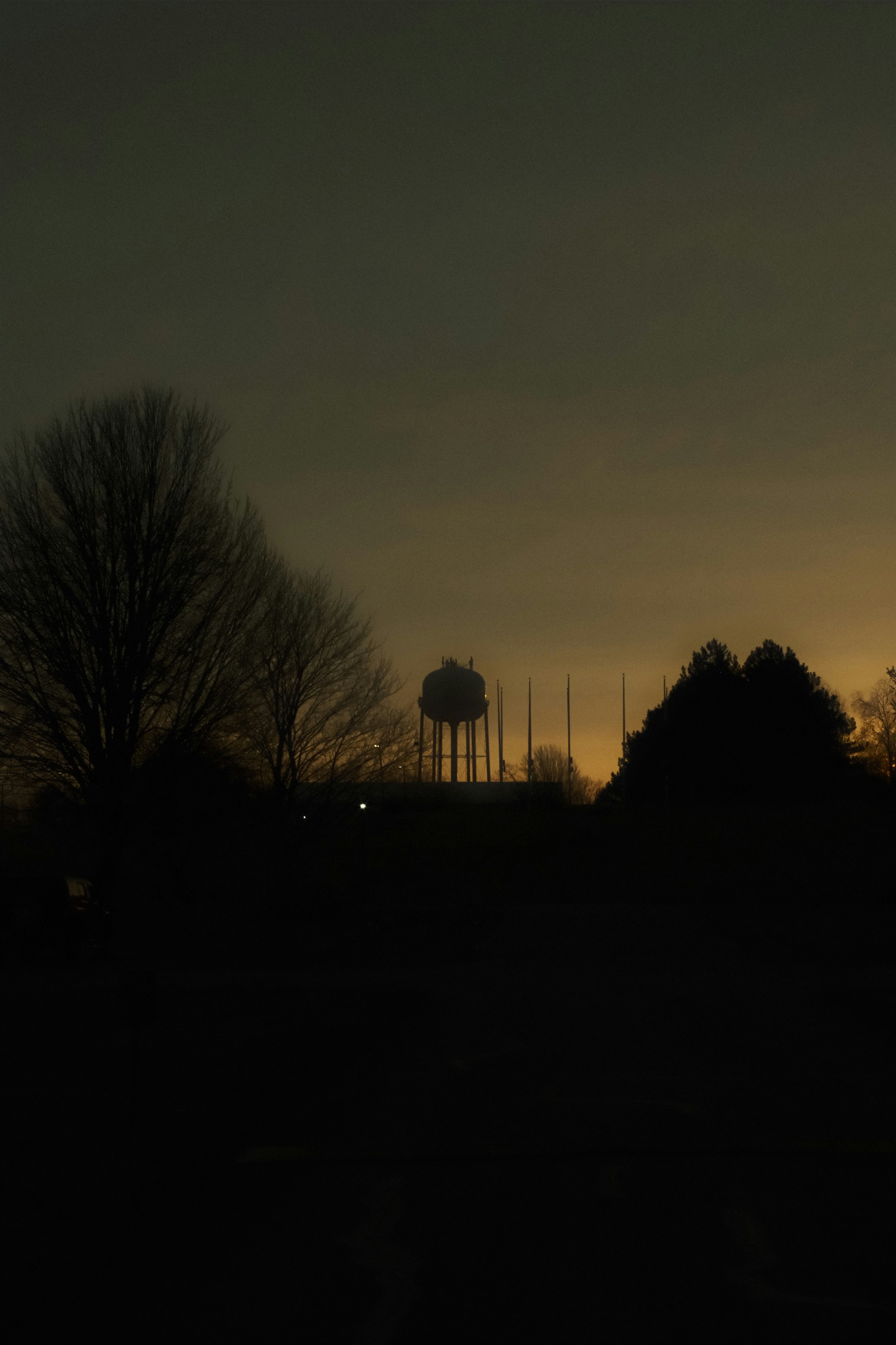 Water tower silhouetted against a dusky sky.