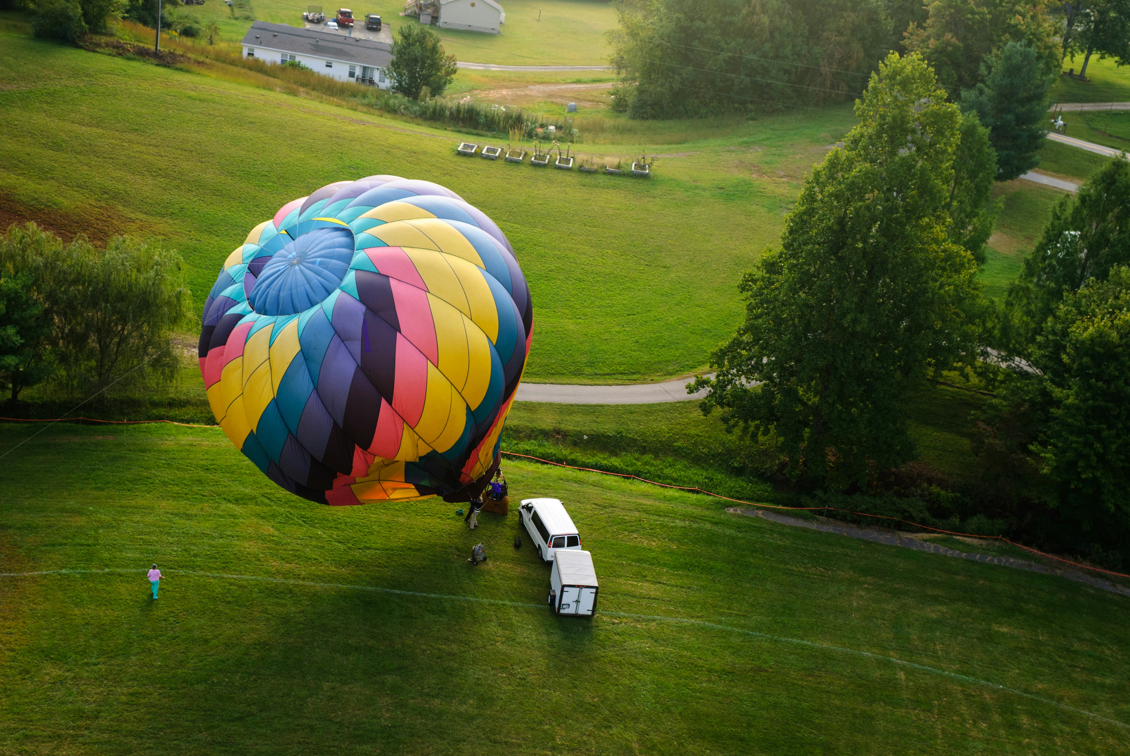 A colorful hot air balloon being prepared for flight.