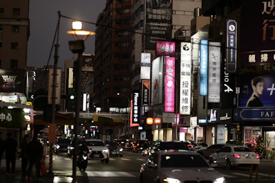 City street with illuminated signs at dusk