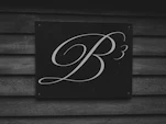 A stylized b3 logo on a wooden wall