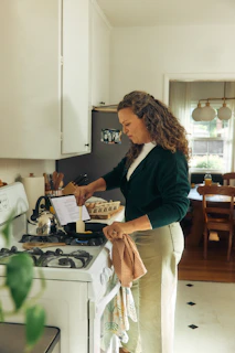 Woman following recipe on tablet in kitchen.