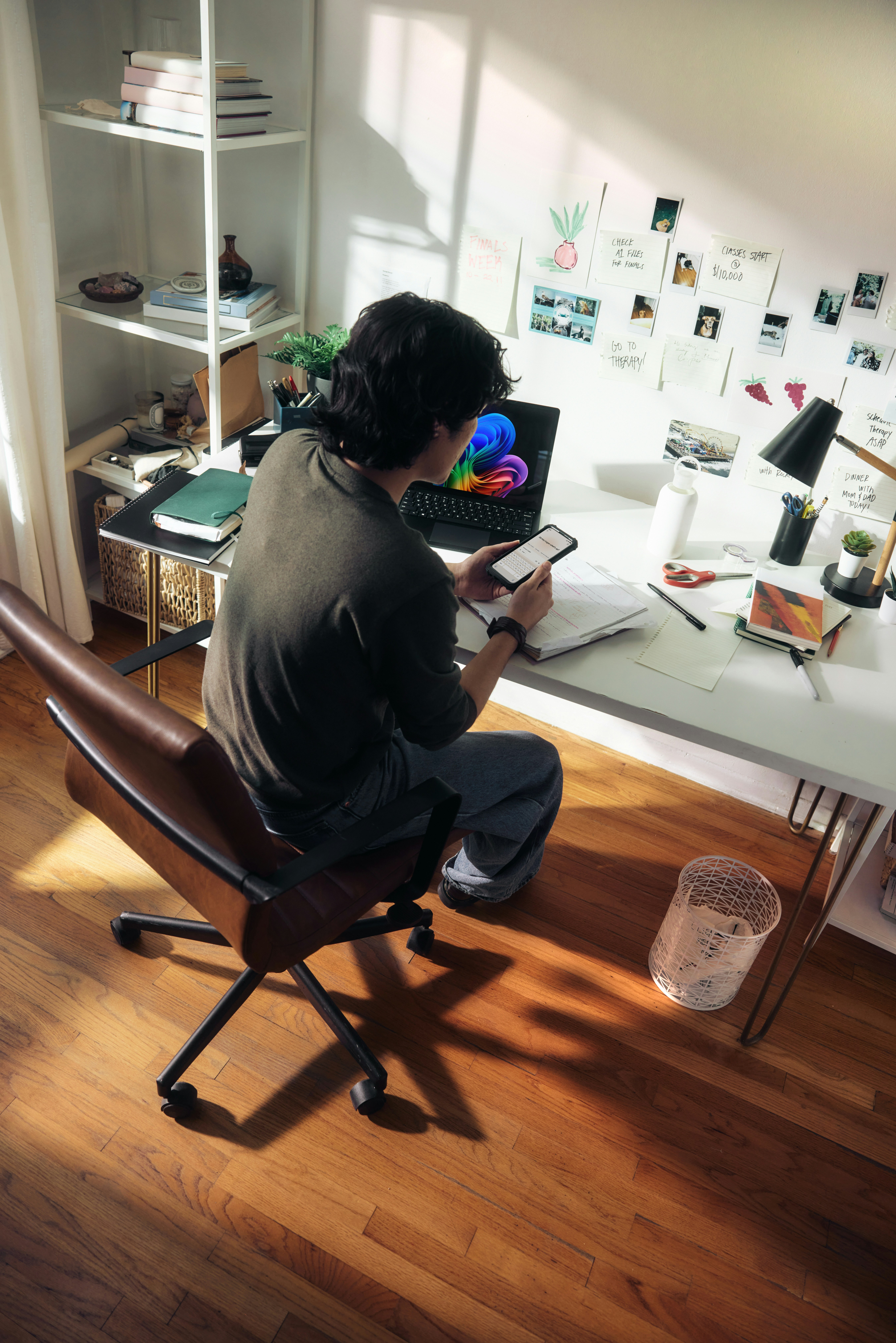 Man working at desk with laptop and phone
