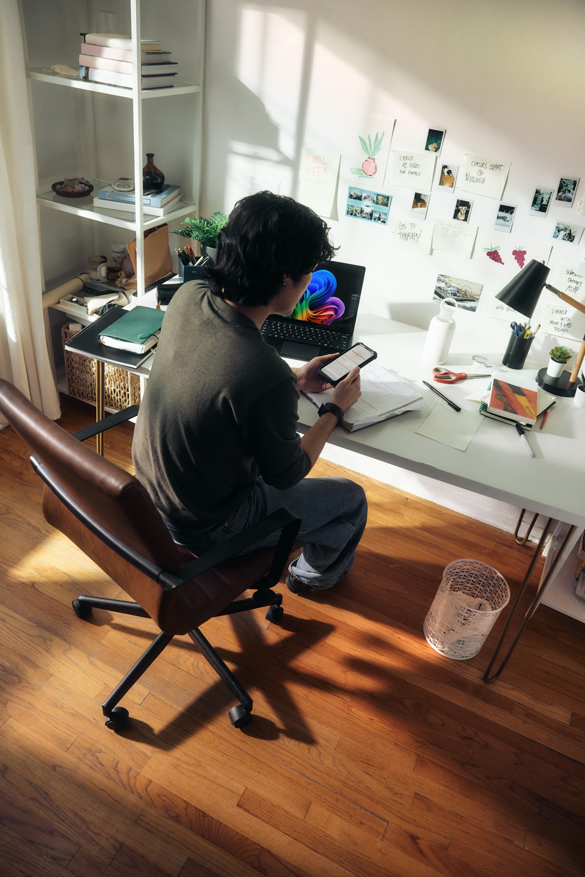 A solo developer working at a desk with a laptop and phone