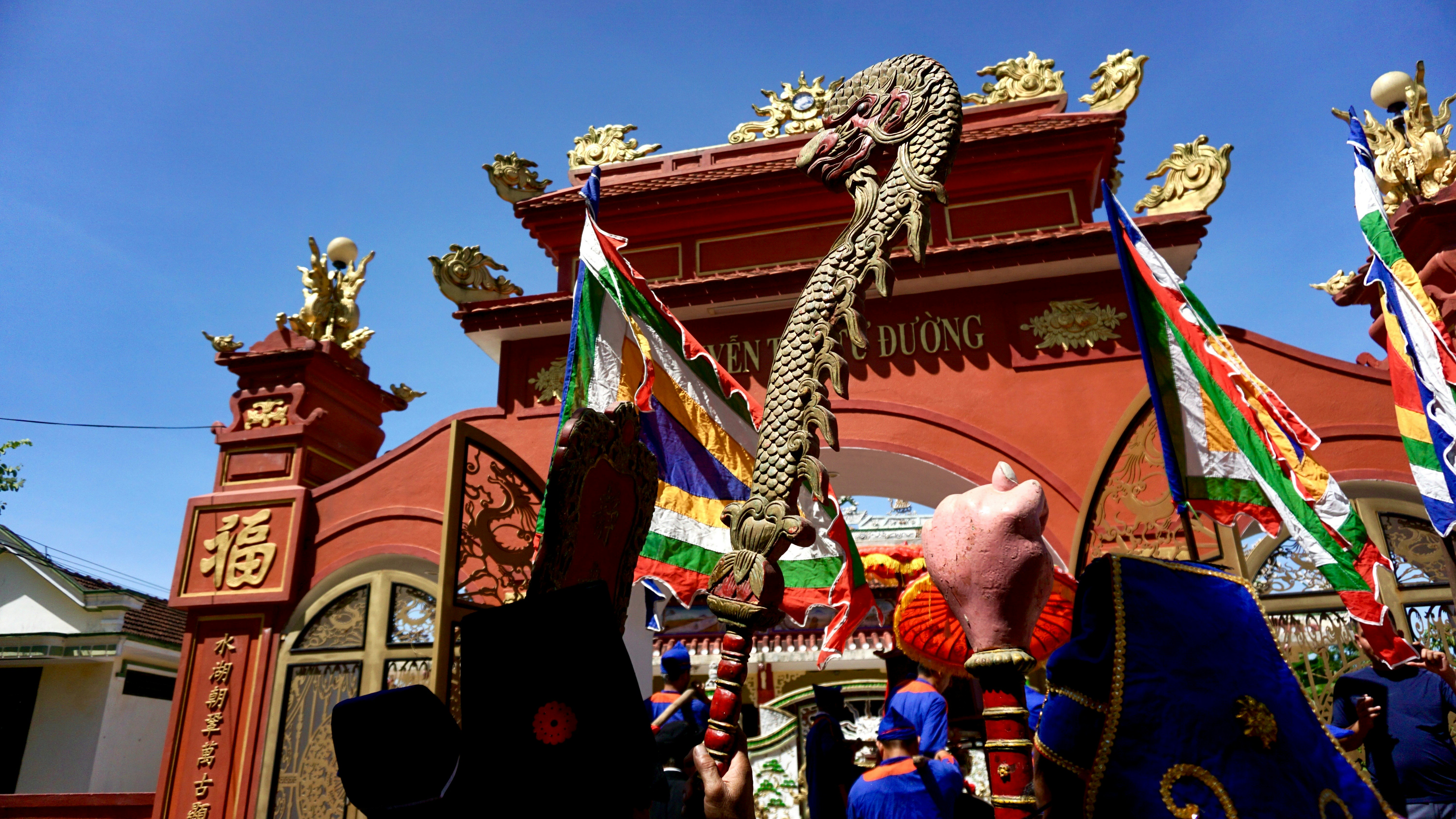 Ornate temple entrance with dragon and flags