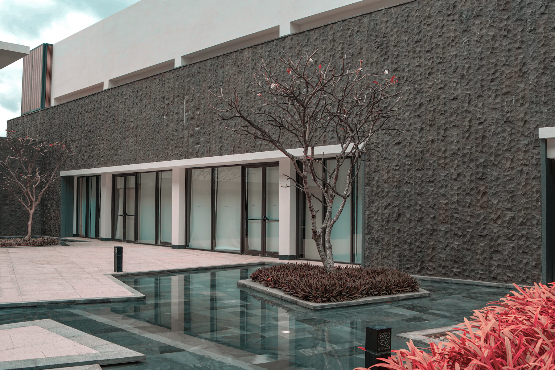 Reference photograph of a quiet contemporary courtyard with a reflecting water feature
