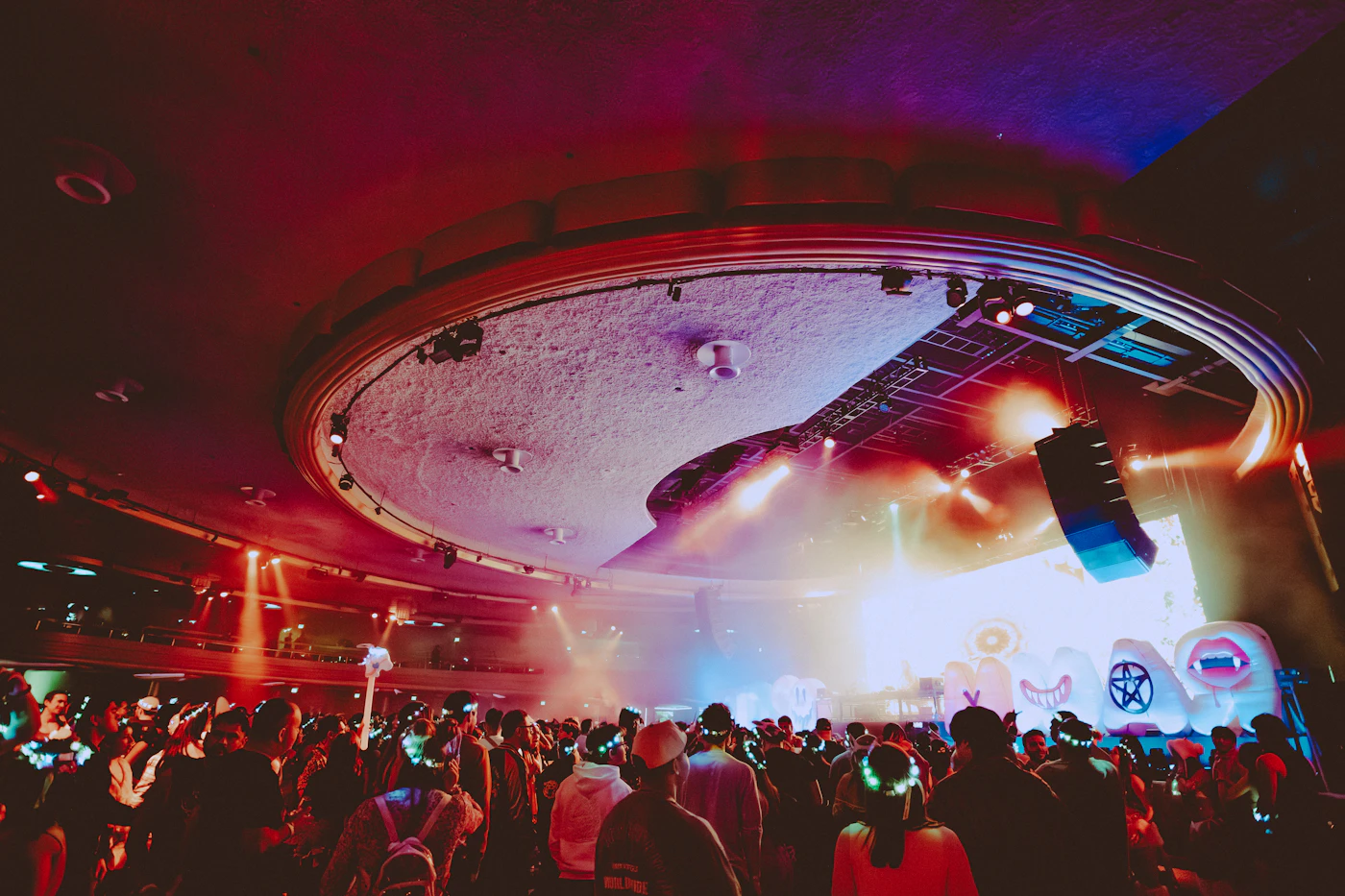 Fans holding glow sticks at a concert