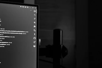 Computer monitor displaying code in a dark room.