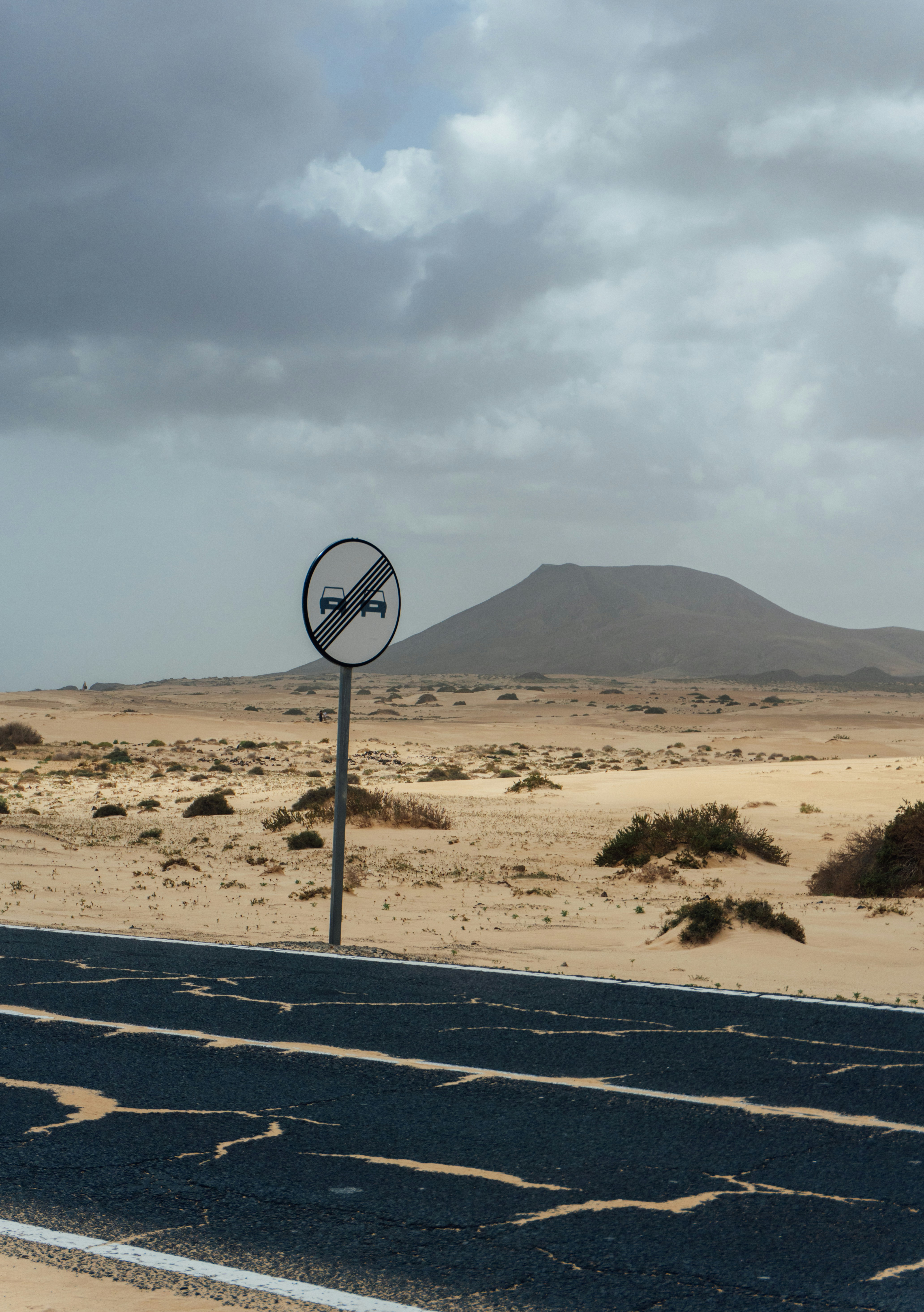 Road sign in a desert landscape with mountains.