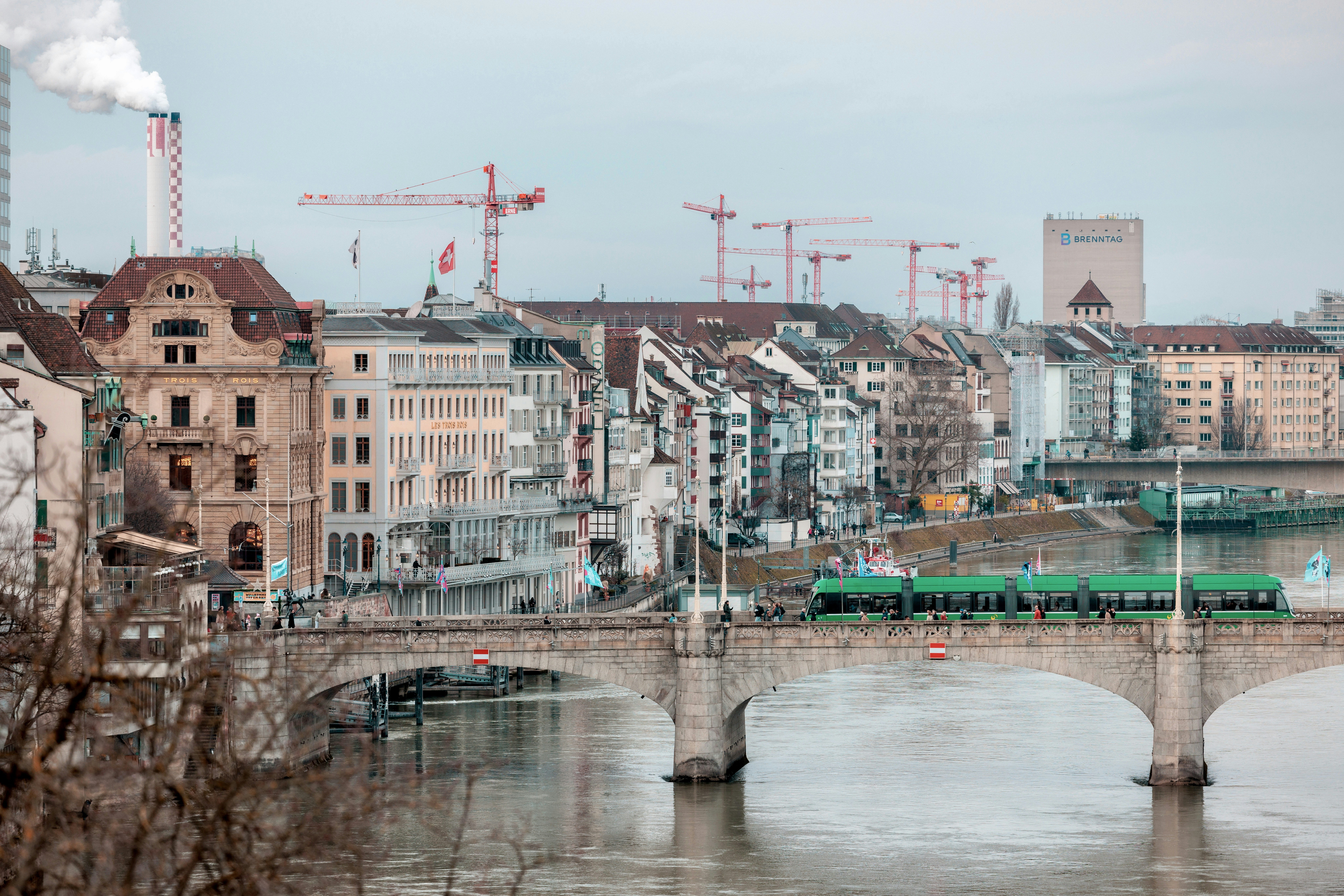 Cityscape with bridge over river and cranes