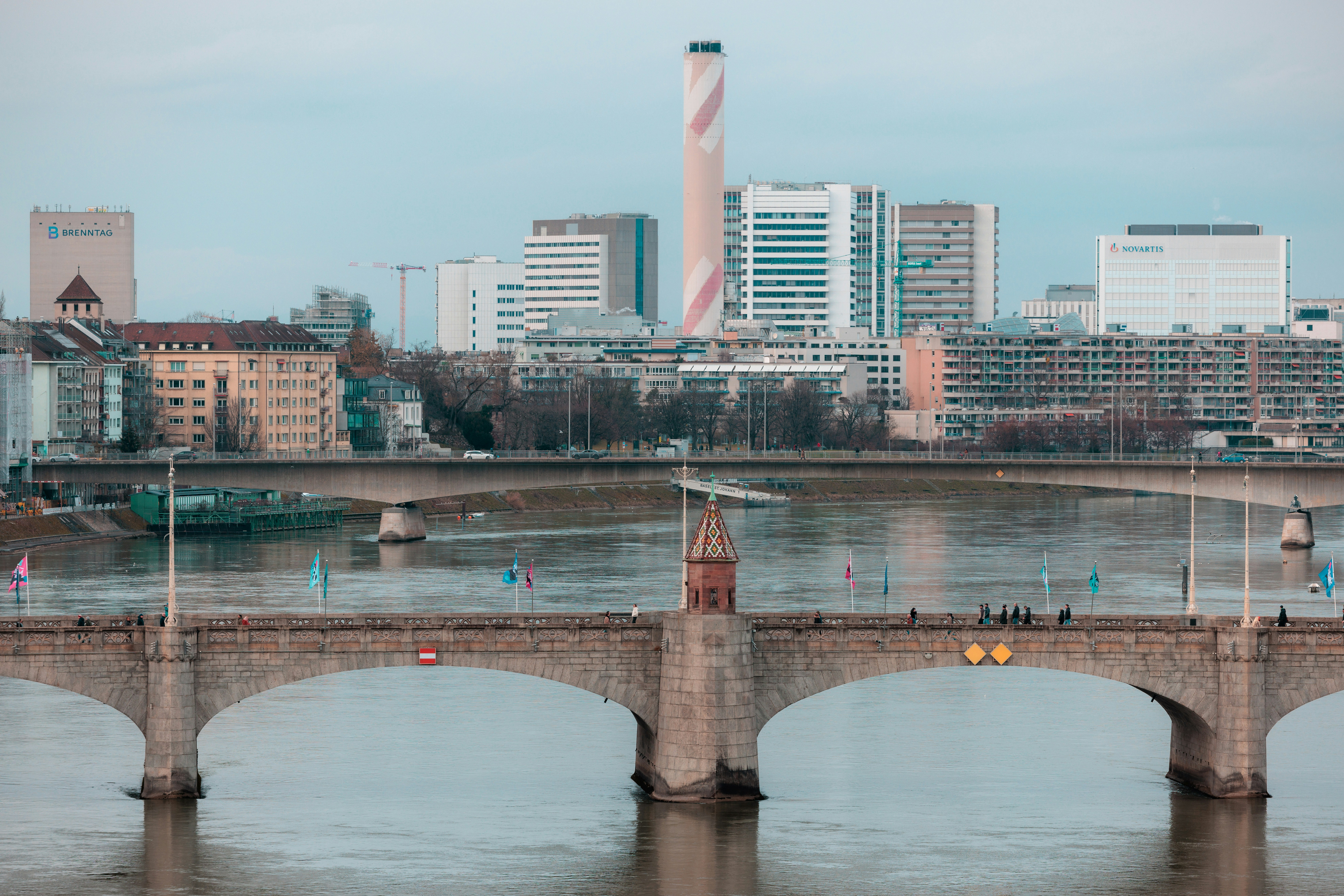 Stone bridge over river with city skyline background