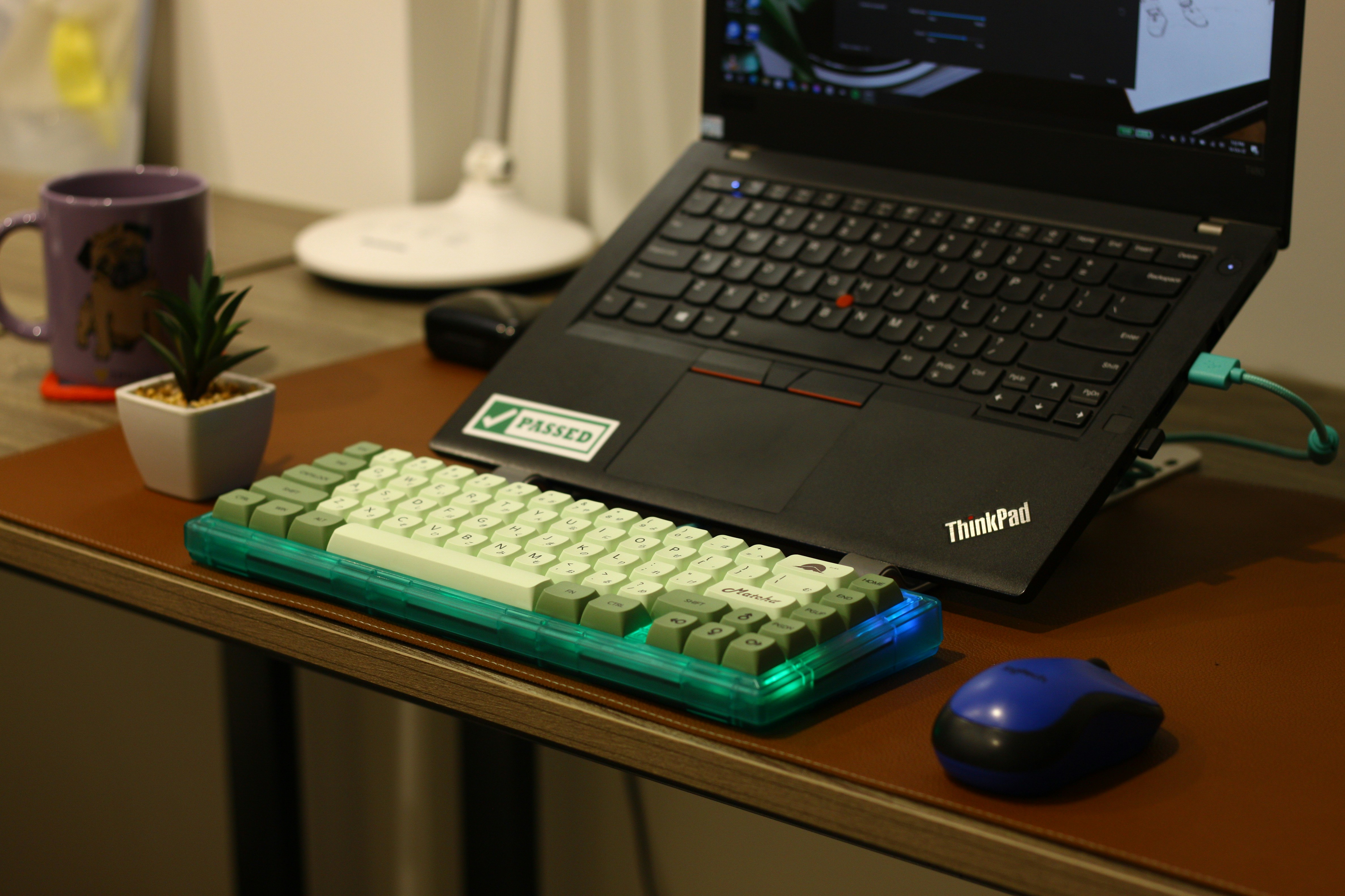 A laptop with a mechanical keyboard and mouse.