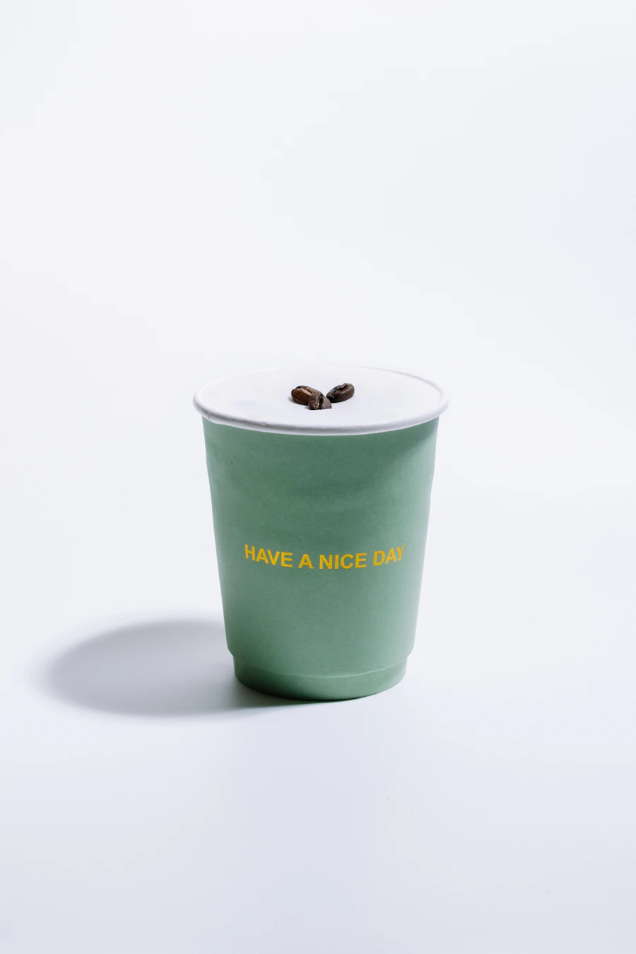Branded coffee cup held in a hand