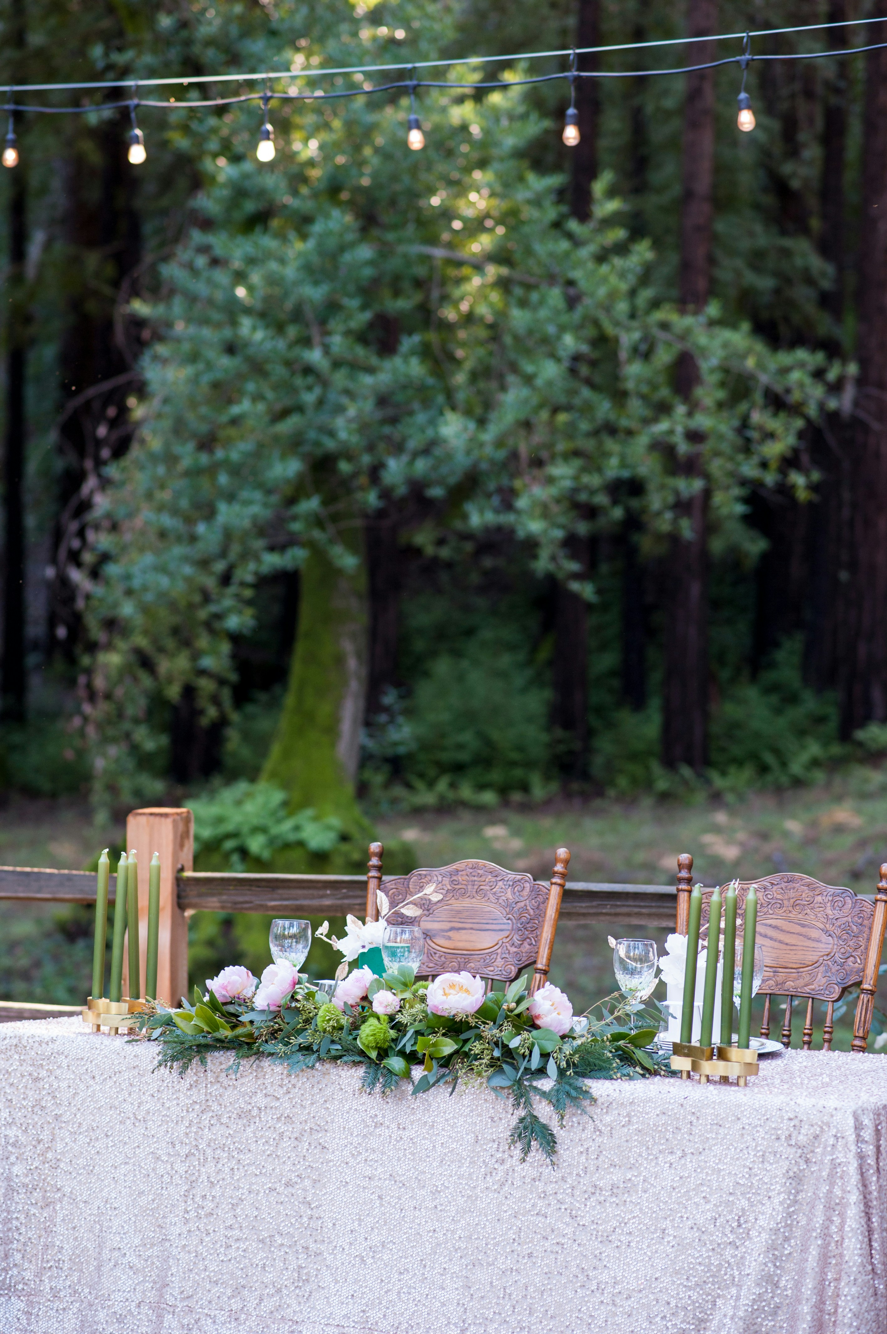 Wedding reception table decorated with flowers and candles.