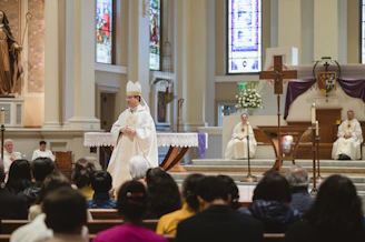 Bishop in full regalia leading a religious ceremony.